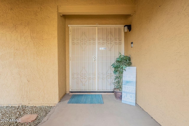 property entrance with stucco siding