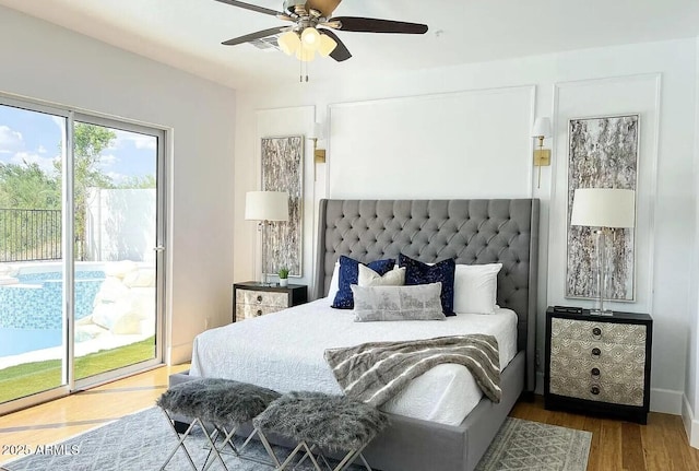 bedroom with ceiling fan, wood-type flooring, and access to exterior