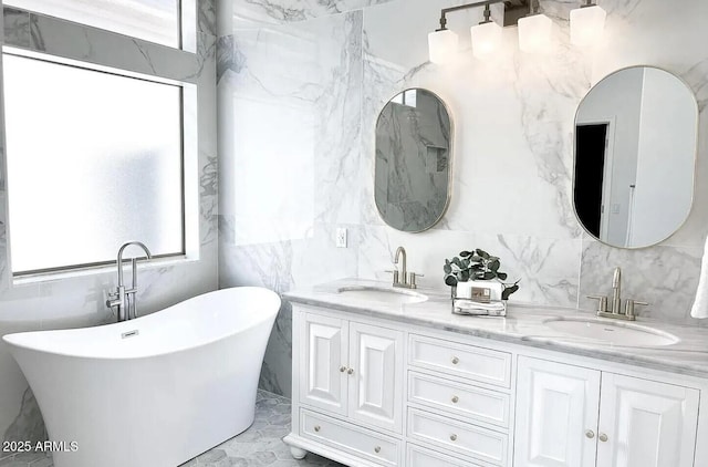 bathroom featuring vanity, plenty of natural light, and a tub to relax in