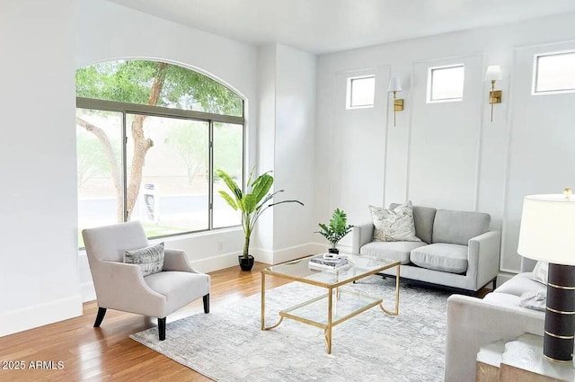 living room with a wealth of natural light and wood-type flooring