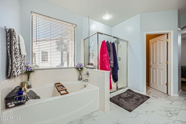 bathroom featuring independent shower and bath