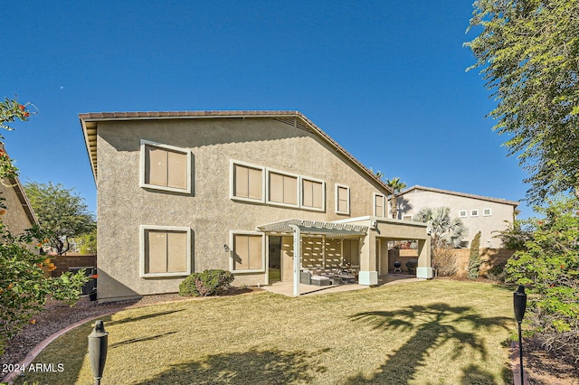 rear view of house with a patio area, a pergola, and a yard