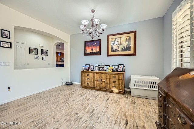 dining area with a notable chandelier and light wood-type flooring