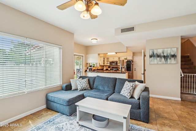 1344 N Brittany Ln, Gilbert, AZ 85233 - living room with stairs, ceiling fan, light tile patterned floors, and baseboards