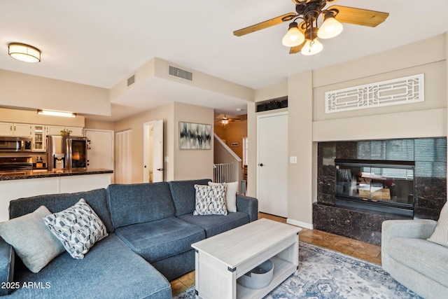 1344 N Brittany Ln, Gilbert, AZ 85233 - living room featuring a ceiling fan, stairway, and tile patterned flooring