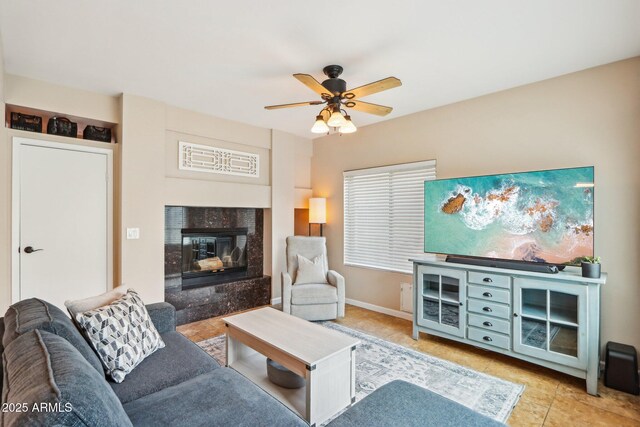 1344 N Brittany Ln, Gilbert, AZ 85233 - living area with ceiling fan, a high end fireplace, tile patterned flooring, and baseboards