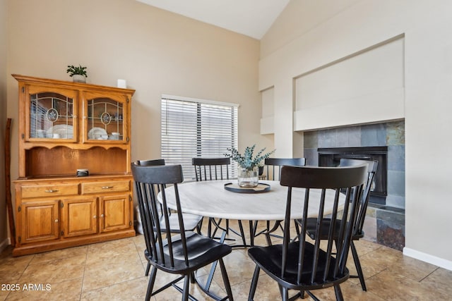 1344 N Brittany Ln, Gilbert, AZ 85233 - dining area with high vaulted ceiling, a tiled fireplace, and baseboards