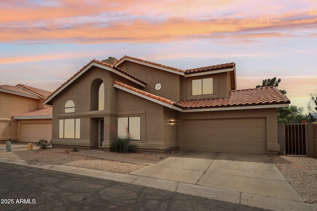1344 N Brittany Ln, Gilbert, AZ 85233 - mediterranean / spanish-style home with concrete driveway, stucco siding, and a tiled roof