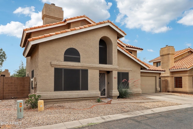 1344 N Brittany Ln, Gilbert, AZ 85233 - mediterranean / spanish home with a garage, stucco siding, a chimney, concrete driveway, and a tiled roof