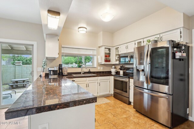 1344 N Brittany Ln, Gilbert, AZ 85233 - kitchen featuring appliances with stainless steel finishes, a sink, tile countertops, a peninsula, and white cabinetry