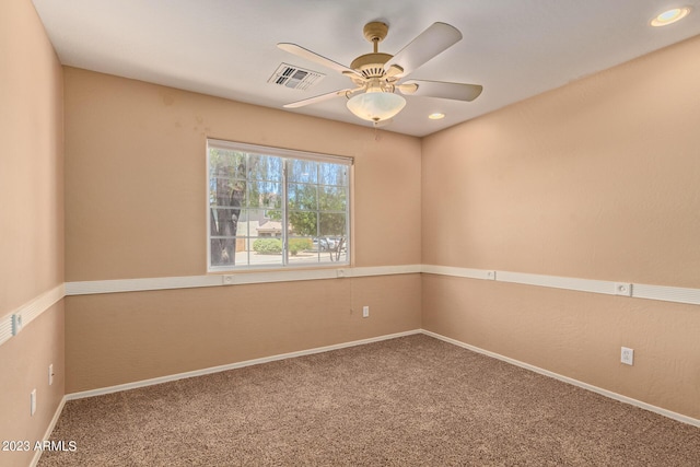 empty room with ceiling fan and carpet