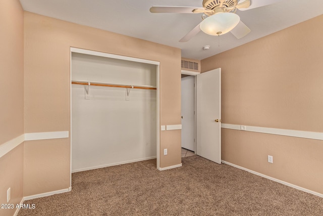 unfurnished bedroom featuring ceiling fan, a closet, and carpet