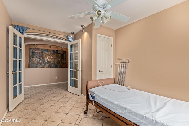 bedroom featuring ceiling fan, light tile patterned floors, and french doors