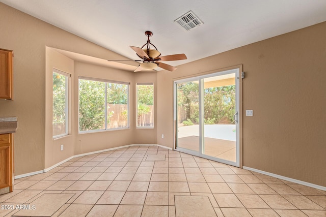 tiled spare room with ceiling fan and lofted ceiling