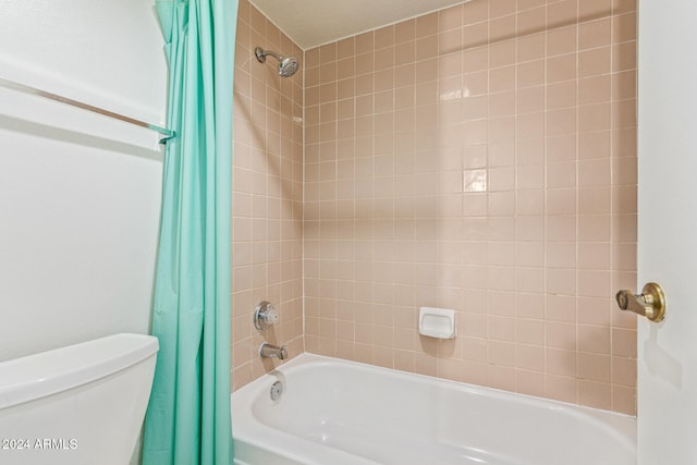 bathroom with toilet and shower / tub combo with curtain