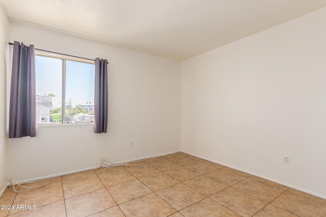 spare room featuring light tile patterned floors