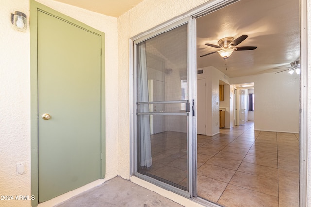 doorway to property featuring ceiling fan