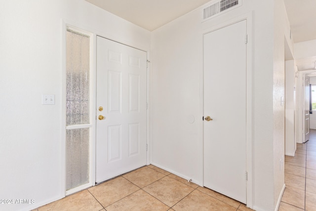 foyer entrance with light tile patterned floors