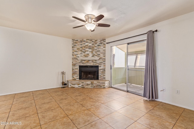 unfurnished living room featuring a fireplace, light tile patterned floors, and ceiling fan