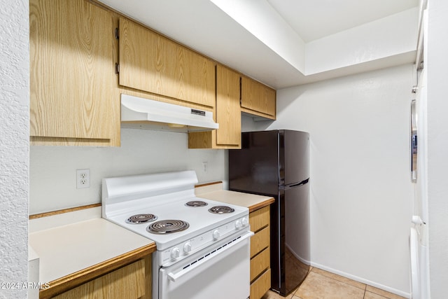 kitchen with electric range, light tile patterned floors, and black fridge