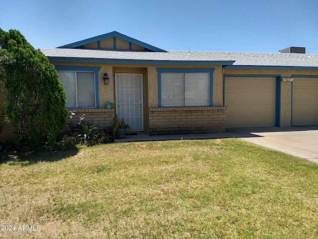 single story home featuring a garage and a front yard