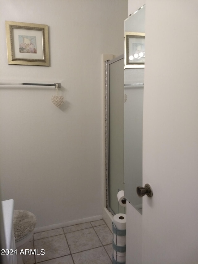 bathroom with tile patterned flooring and walk in shower