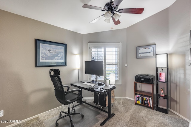 carpeted home office featuring baseboards and a ceiling fan