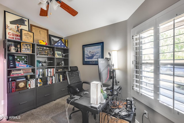 home office with a ceiling fan, carpet, and vaulted ceiling