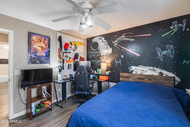 bedroom featuring baseboards, a ceiling fan, and wood finished floors
