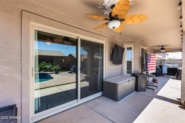 view of patio with fence and a ceiling fan