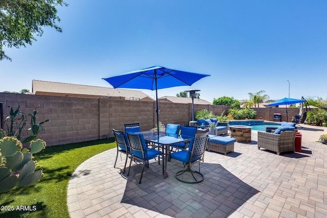 view of patio featuring a fenced backyard and outdoor dining area