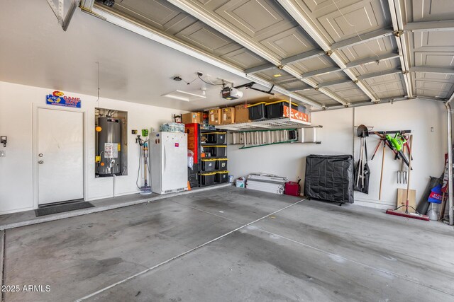garage featuring freestanding refrigerator, a garage door opener, and gas water heater
