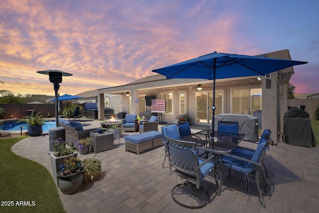 view of patio / terrace featuring a fenced backyard, a fenced in pool, outdoor dining area, and an outdoor hangout area