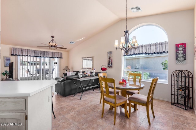 dining space featuring light tile patterned flooring, lofted ceiling, and ceiling fan with notable chandelier