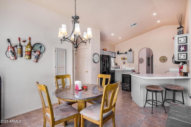 dining area with an inviting chandelier and vaulted ceiling