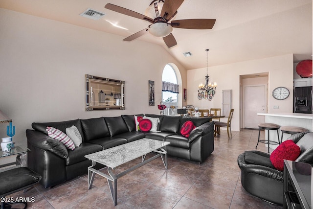 living room with dark tile patterned floors, vaulted ceiling, and ceiling fan with notable chandelier