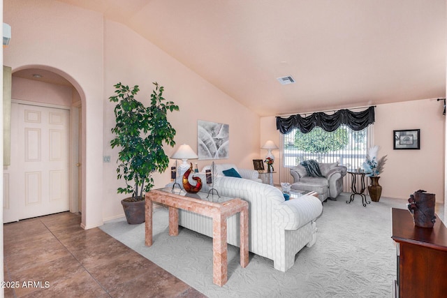 living room featuring lofted ceiling and tile patterned flooring