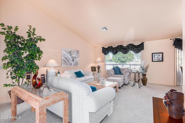 carpeted living room featuring vaulted ceiling