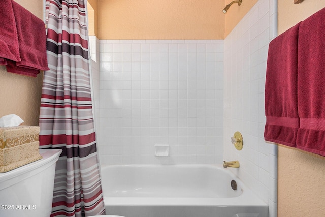 bathroom featuring toilet and shower / tub combo with curtain