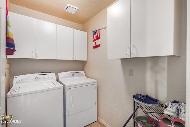 laundry area with cabinets and washer and clothes dryer