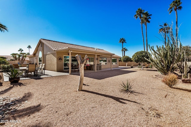 back of property featuring a patio area