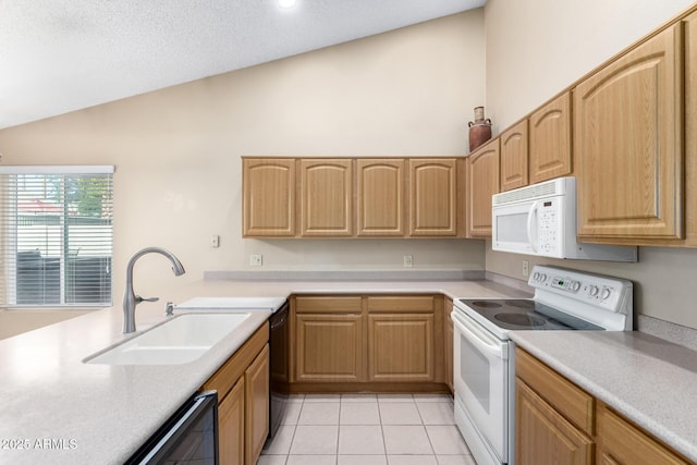 kitchen with a sink, white appliances, light brown cabinetry, vaulted ceiling, and light countertops