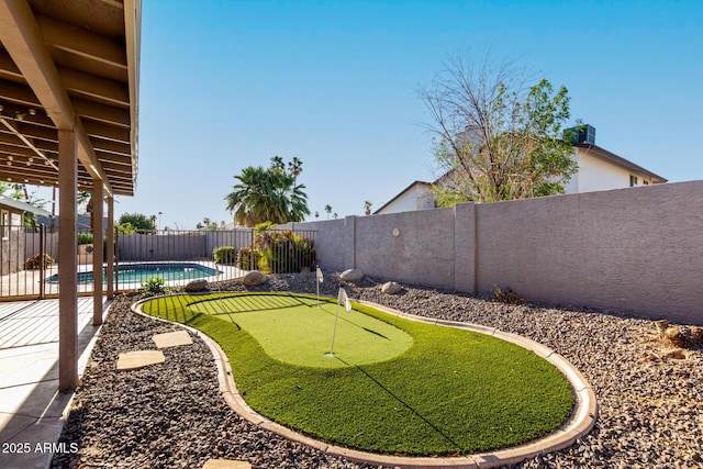 view of yard featuring a fenced backyard, a fenced in pool, and a patio area