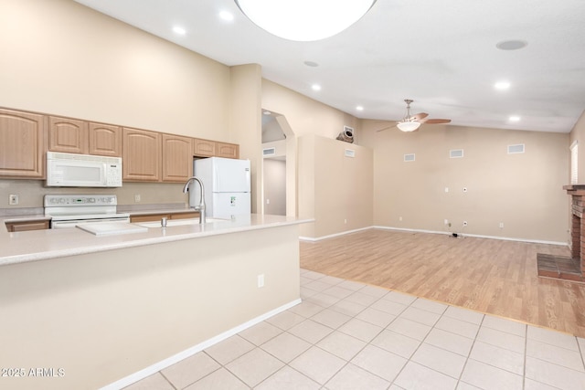 kitchen featuring white appliances, light brown cabinets, light countertops, visible vents, and a ceiling fan