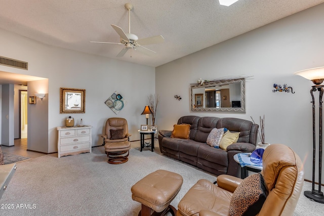 living room featuring light carpet, ceiling fan, vaulted ceiling, and a textured ceiling