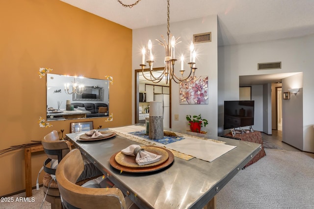 dining area with a towering ceiling, a chandelier, and carpet