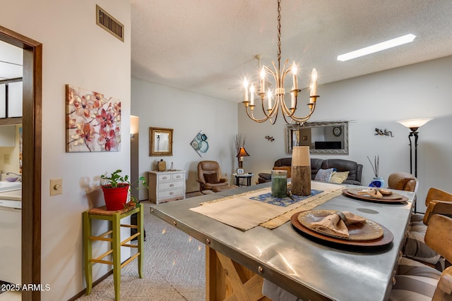 carpeted dining area with an inviting chandelier and a textured ceiling