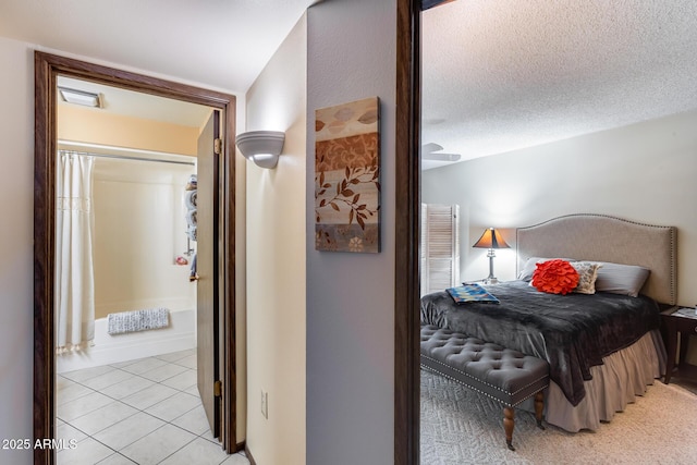 bedroom featuring light tile patterned floors and a textured ceiling