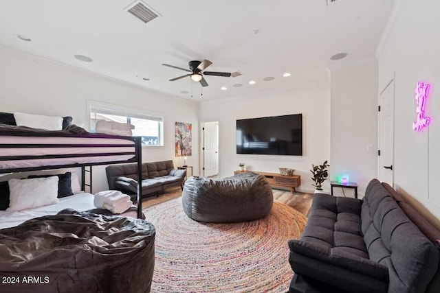 bedroom with hardwood / wood-style flooring, ceiling fan, and ornamental molding