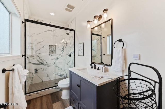 bathroom featuring crown molding, plenty of natural light, wood-type flooring, and a shower with shower door